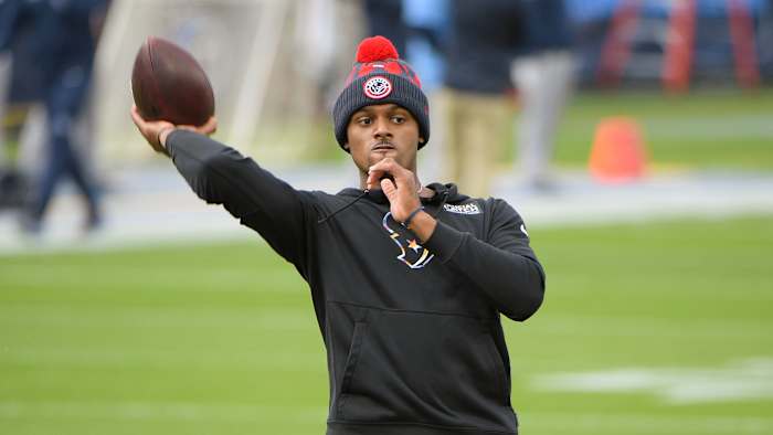 Deshaun Watson holds a football.